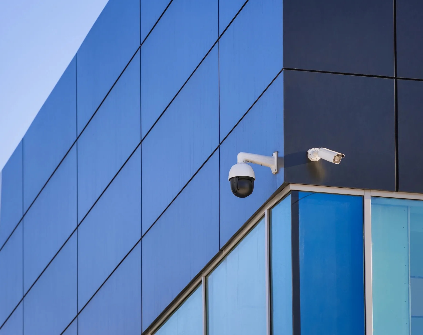 Professional security camera installation on a modern building